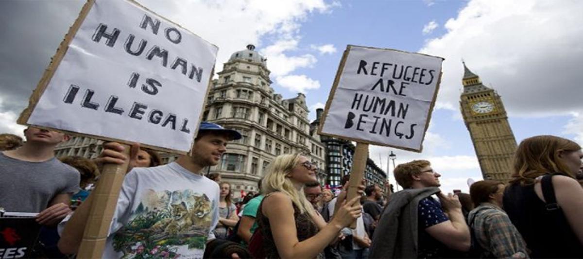 Smoke bombs thrown at police during London migrant protest